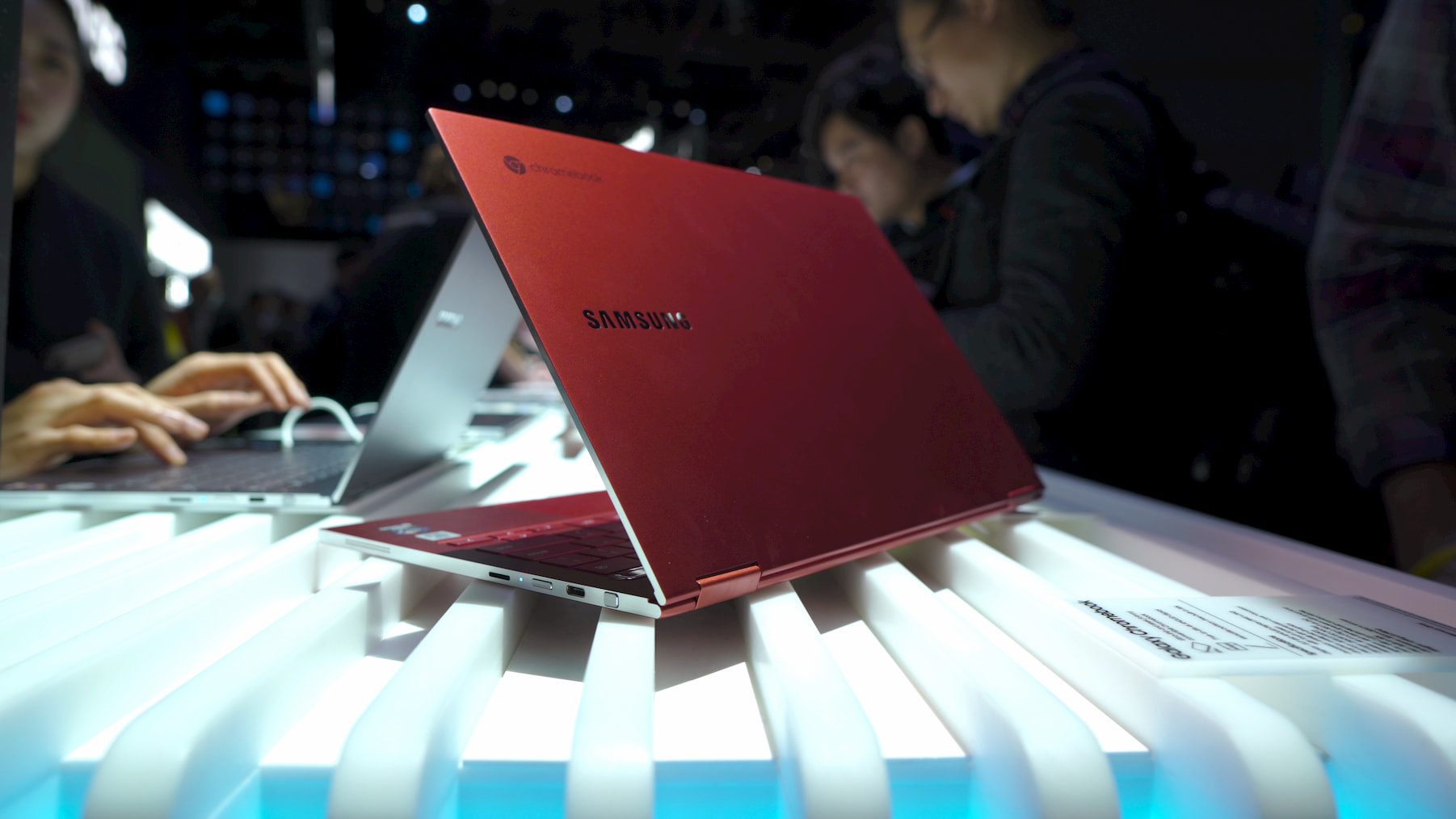 Red Samsung Chromebook half open on a white light 